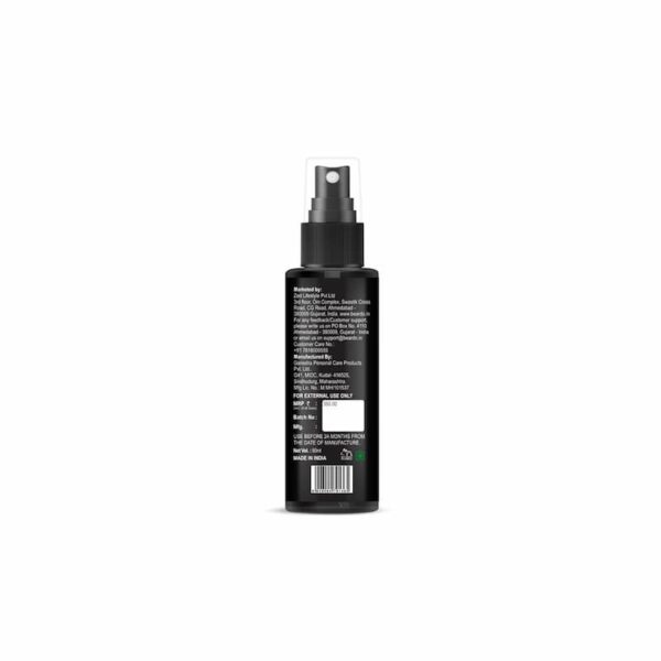 Back view of black hair serum spray bottle with barcode, label details, and spray nozzle